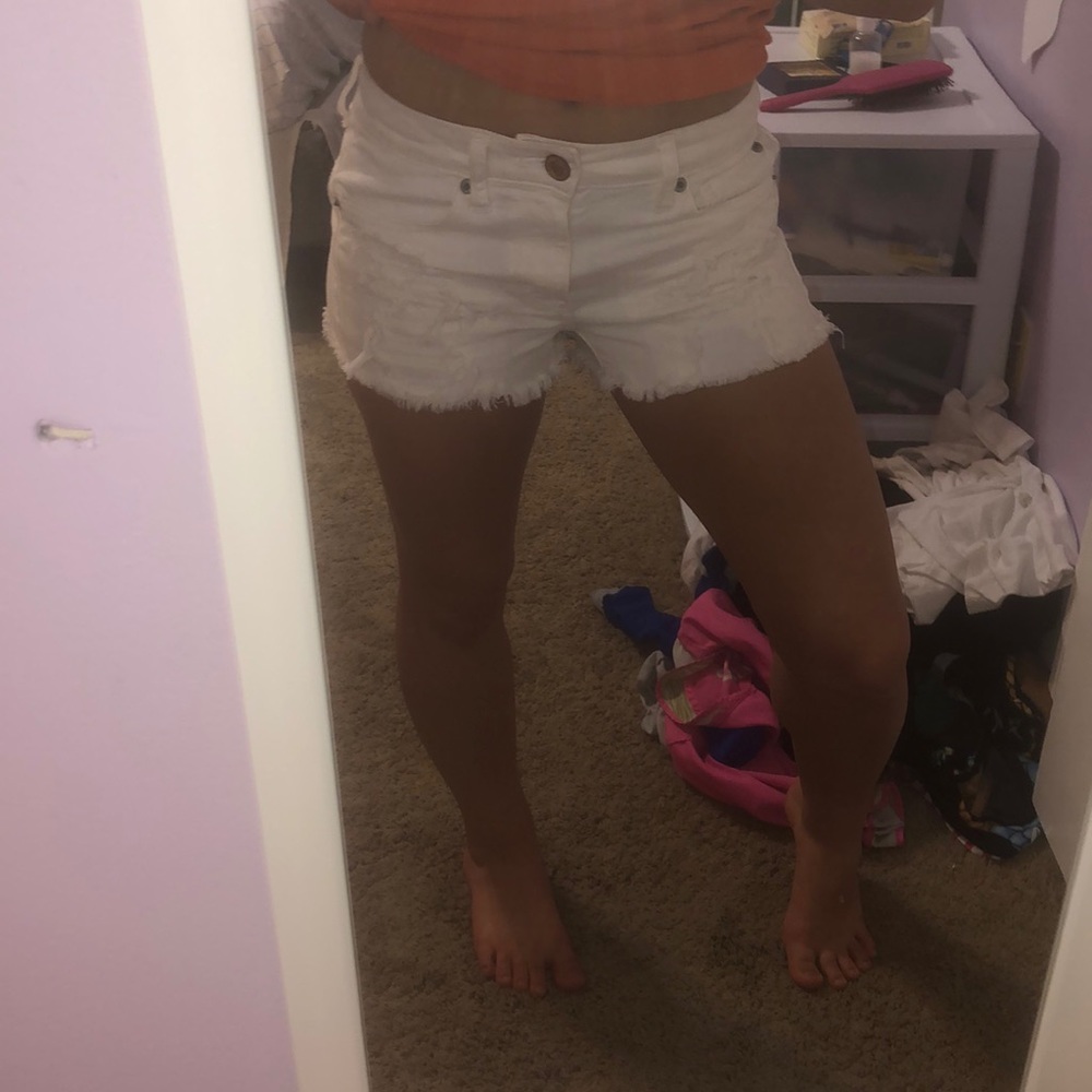 Distressed white jean shorts